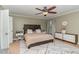 This bedroom features a ceiling fan, and accent rug, and ample natural light from the window at 2407 Cattail Pond Dr, Zebulon, NC 27597