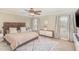 Cozy bedroom featuring a ceiling fan, plush rug, and large windows at 2407 Cattail Pond Dr, Zebulon, NC 27597