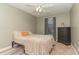 A simply decorated bedroom with neutral colors, a dark dresser and a ceiling fan at 2407 Cattail Pond Dr, Zebulon, NC 27597