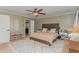 This bedroom offers a view into the bathroom, a ceiling fan, and neutral tones throughout at 2407 Cattail Pond Dr, Zebulon, NC 27597