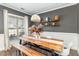Bright dining room with hardwood floors, stylish lighting, and large window at 2407 Cattail Pond Dr, Zebulon, NC 27597