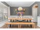 Bright dining room with hardwood floors, stylish lighting, and ample seating at 2407 Cattail Pond Dr, Zebulon, NC 27597