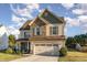 Charming two-story home featuring a stone facade, attached two-car garage, and well-maintained lawn at 2407 Cattail Pond Dr, Zebulon, NC 27597