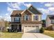 Charming home with a stone-accented facade, inviting front porch, and well-manicured landscaping for curb appeal at 2407 Cattail Pond Dr, Zebulon, NC 27597