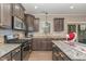 Modern kitchen with granite counters, stainless steel appliances, and a center island at 2407 Cattail Pond Dr, Zebulon, NC 27597