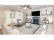 Cozy living room with fireplace, built-in shelving, and large windows at 2407 Cattail Pond Dr, Zebulon, NC 27597