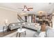 Open concept living room with sectional sofa, hardwood floors, and view of kitchen at 2407 Cattail Pond Dr, Zebulon, NC 27597