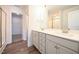 Bathroom featuring dual sinks, modern fixtures, and a walk-in shower at 247 Johnson Ridge Way, Four Oaks, NC 27524