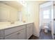 This bathroom features a double vanity, and a view of the tub and toilet at 247 Johnson Ridge Way, Four Oaks, NC 27524