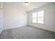 This carpeted bedroom has white walls and a large window at 247 Johnson Ridge Way, Four Oaks, NC 27524