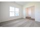 A carpeted bedroom is a blank canvas with neutral colors and a bright window with natural lighting at 247 Johnson Ridge Way, Four Oaks, NC 27524