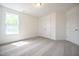 This carpeted bedroom features a window and double closets at 247 Johnson Ridge Way, Four Oaks, NC 27524