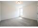 This carpeted bedroom has white walls and a window at 247 Johnson Ridge Way, Four Oaks, NC 27524