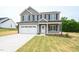 Charming two-story home featuring a gray exterior, two-car garage, and well-manicured lawn at 247 Johnson Ridge Way, Four Oaks, NC 27524