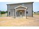 Back of home featuring a small covered patio and light gray vinyl siding at 247 Johnson Ridge Way, Four Oaks, NC 27524