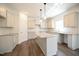 Beautiful kitchen features a center island, stone countertops, white cabinets and stainless steel appliances at 247 Johnson Ridge Way, Four Oaks, NC 27524