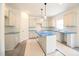Kitchen featuring an island, white cabinetry and stainless sink at 247 Johnson Ridge Way, Four Oaks, NC 27524