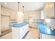 Kitchen featuring an island, white cabinetry, subway backsplash and stainless sink at 247 Johnson Ridge Way, Four Oaks, NC 27524