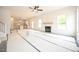 Open-concept living area with a fireplace and large windows for lots of natural light at 247 Johnson Ridge Way, Four Oaks, NC 27524