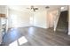 Sun-filled living room with modern vinyl flooring, a fireplace, and an open staircase, creating a welcoming and spacious atmosphere at 247 Johnson Ridge Way, Four Oaks, NC 27524