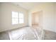 Bright, empty living room showcasing ample natural light through a large window at 247 Johnson Ridge Way, Four Oaks, NC 27524