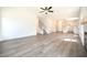 A bright, open living space flows into a modern kitchen and features stylish vinyl flooring, a staircase, and plenty of light at 247 Johnson Ridge Way, Four Oaks, NC 27524