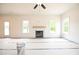Bright living room featuring a fireplace and large windows that offer ample natural light at 247 Johnson Ridge Way, Four Oaks, NC 27524