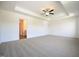 Spacious bedroom with tray ceiling, ceiling fan and large windows at 247 Johnson Ridge Way, Four Oaks, NC 27524