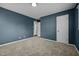 Spacious bedroom with neutral carpeting and blue walls at 2522 Hickory Ave, Burlington, NC 27215