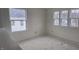 Bright bedroom featuring multiple windows offering ample natural light and neighborhood views at 253 Windsor Mill Rd, Rolesville, NC 27571