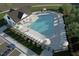 Aerial view of the community pool area with lounge chairs, umbrellas and trees at 253 Windsor Mill Rd, Rolesville, NC 27571
