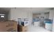 Spacious open layout with kitchen featuring white cabinets, an island, and awaiting appliance installation at 253 Windsor Mill Rd, Rolesville, NC 27571