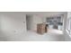 Bright, spacious living area with large windows offers seamless flow into the kitchen space at 253 Windsor Mill Rd, Rolesville, NC 27571