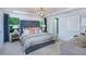 Main bedroom with tufted headboard and ensuite bathroom at 2904 Huxley Way, Apex, NC 27502