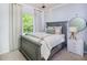 Bright bedroom with a gray bed frame, soft bedding, and a large window at 2916 Huxley Way, Apex, NC 27502