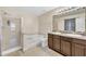 Bathroom with double sinks, granite countertop, garden tub, and shower at 309 Coalyard Dr, Garner, NC 27529