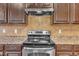 Stainless steel appliances and dark wood cabinets in this kitchen at 309 Coalyard Dr, Garner, NC 27529