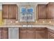 Kitchen with wood cabinets, granite countertops, and double sink at 309 Coalyard Dr, Garner, NC 27529
