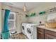 Laundry room with washer, dryer, shelving, and ample storage at 309 Coalyard Dr, Garner, NC 27529