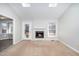 Inviting living room featuring a brick fireplace, carpeted floors, and natural light from skylights at 3401 Belin Ct, Raleigh, NC 27616