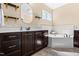 Luxurious bathroom with dark cabinets, quartz countertops, soaking tub, and decorative backsplash at 347 Country Mill Way, Fuquay Varina, NC 27526