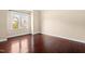 Bright bedroom with gleaming hardwood floors, a large window, and neutral walls at 347 Country Mill Way, Fuquay Varina, NC 27526