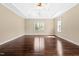 Spacious primary bedroom with hardwood floors, tray ceilings, and natural light at 347 Country Mill Way, Fuquay Varina, NC 27526