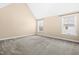 Light-filled bedroom with neutral walls, carpet, and windows with a view at 347 Country Mill Way, Fuquay Varina, NC 27526
