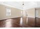 Spacious bedroom boasting hardwood floors, a tray ceiling, and natural light from three windows at 347 Country Mill Way, Fuquay Varina, NC 27526