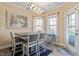 Dining room with modern lighting, table and chairs, and a door to the patio at 347 Country Mill Way, Fuquay Varina, NC 27526