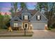 Charming two-story home with a manicured lawn, a two-car garage, and beautiful landscaping at 347 Country Mill Way, Fuquay Varina, NC 27526