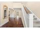 Elegant foyer featuring hardwood floors, a staircase, and arched doorways leading to other rooms at 347 Country Mill Way, Fuquay Varina, NC 27526