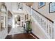 Inviting foyer with hardwood floors, staircase, and views into other living spaces at 347 Country Mill Way, Fuquay Varina, NC 27526