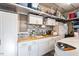 Organized garage featuring a utility sink, custom cabinets, shelving, and ample storage space at 347 Country Mill Way, Fuquay Varina, NC 27526